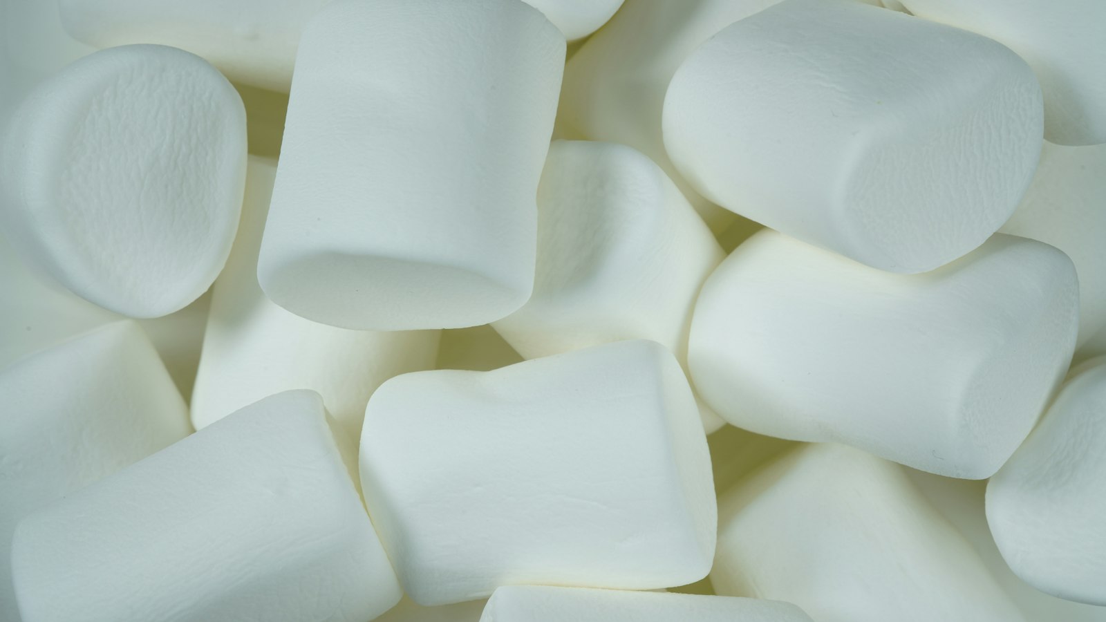 A close view of plain white marshmallows, the grocery store confection homeowners are told to push down into mole runs as a yard remedy