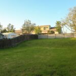 Groundhog or Mole? What Is Digging Up Your Cincinnati Yard 1 Fenced backyard lawn in a residential neighborhood where groundhog and mole digging first shows up